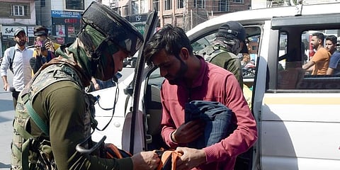 Security personnel check bags of commuters during a high alert after a militant attack on civilians, in Srinagar on Saturday. (Photo | ANI)