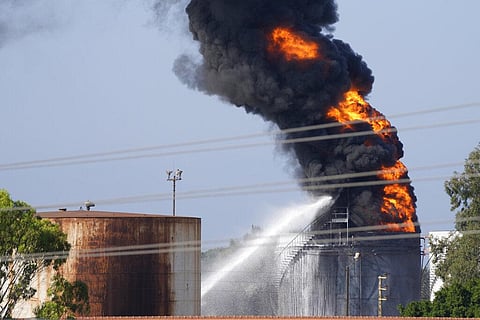 Firefighters work to extinguish a fire in an oil facility in the southern town of Zahrani, south of the port city of Sidon, Lebanon, Monday. (Photo | AP)