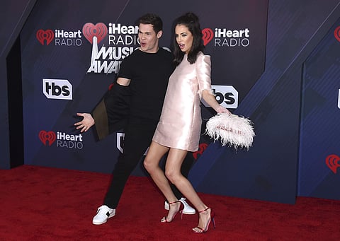 Adam Devine, left, and Chloe Bridges arrive at the iHeartRadio Music Awards.(File Photo | AP)