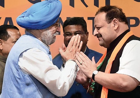 Union Minister Hardeep Singh Puri welcomes Devendra Rana to the BJP. (Photo | Parveen Negi, EPS)