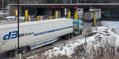 Truck traffic from Canada waits to cross the border into the United States in Derby Line Vt. (Photo | AP)
