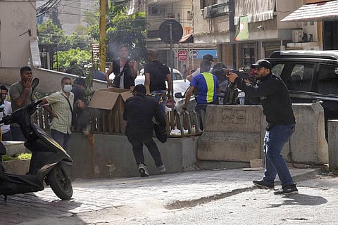 Supporters of a Shiite group allied with Hezbollah fire weapons during armed clashes that erupted during a protest in the southern Beirut suburb of Dahiyeh, Lebanon, Oct. 14, 2021. (Photo | AP)