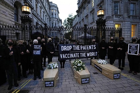 Global Justice campaigners stand by fake coffins to highlight the number of COVID-19 deaths globally, in London, Tuesday, Oct. 12, 2021. (Photo | AP)