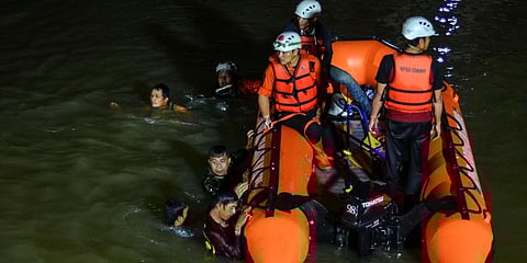 Rescuers search for victims of drowning in a river in Ciamis, West Java, Indonesia, Friday, Oct. 15, 2021.. (Photo | AP)