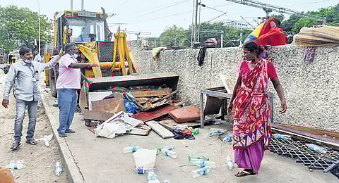 Corporation officials clearing the encroachments near the Gandhi Irwin Road in Egmore on Saturday | R Satish Babu