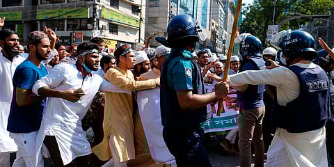 Police clash with Muslim devotees during a protest over an alleged insult to Islam, outside the country’ main Baitul Mukarram Mosque in Dhaka. (Photo| AP)