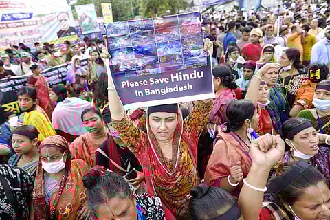 Hundreds of Hindus protesting against attacks on temples and the killing of two Hindu devotees in another district shout slogans in Dhaka, Bangladesh. (Photo | AP)