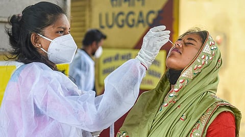 A healthcare worker conducting a swab test for COVID-19.