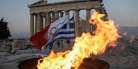 The Olympic Flame burns at the cauldron in front of ancient Parthenon temple atop of the Acropolis hill in Athens, Tuesday, Oct. 19, 2021. (Photo | AP)