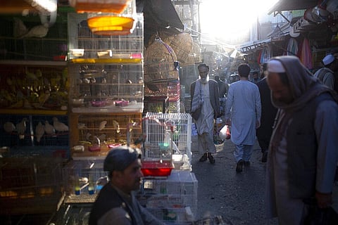 In this Tuesday, Oct. 12, 2021 file photo, Afghans walk through a market in Kabul, Afghanistan. (Photo | AP)