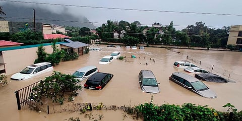 Submerged cars are seen at a flooded hotel resort as extreme rainfall caused the Kosi River to overflow at the Jim Corbett National Park in Uttarakhand. (Photo | AP)