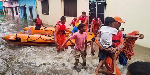 NDRF soldiers rescue people stranded in floodwaters in Udham Singh Nagar, Uttarakhand. (Photo | AP)