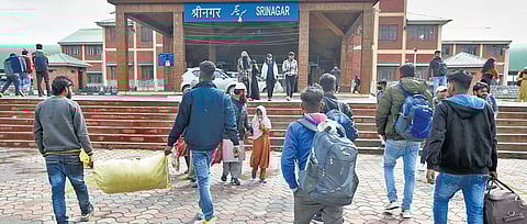 Migrant workers arrive at Srinagar Railway Station on Monday. Killings of non-residents by militants have spread fear. (Photo | PTI)