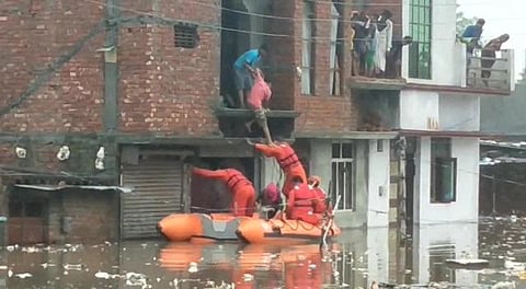 NDRF team carrying out rescue operations at several waterlogged areas in Rudrapur on Tuesday. (Photo | Twitter/ANI)