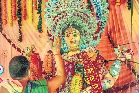 A priest performing Laxmi Puja rituals at a pandal in Bhubaneswar.