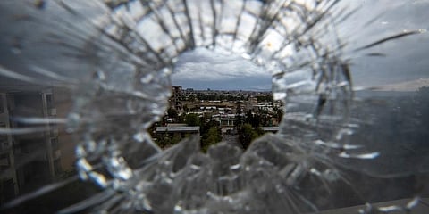 The city of Mekele is seen through a bullet hole in a stairway window of the Ayder Referral Hospital, in the Tigray region of northern Ethiopia. (File photo | AP)