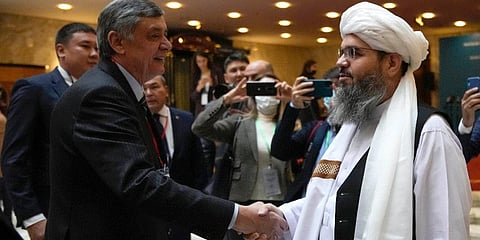 Russian presidential envoy to Afghanistan Zamir Kabulov, left, shake hands with a member of the political delegation from the Afghan Taliban's movement Mawlawi Shahabuddin Dilawar. (Photo | PTI)