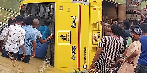 Locals check on the school bus in Srikakulam district. (Photo| EPS)