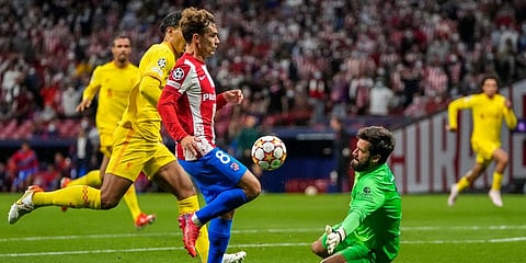 Atletico Madrid's Antoine Griezmann and Liverpool's goalkeeper Alisson (R) during the Champions League Group B match. (Photo | AP)