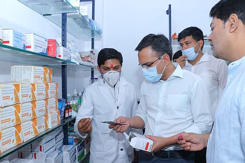 Raipur collector Saurabh Kumar examining the medicines available at a Dhanwantri Medical Store
