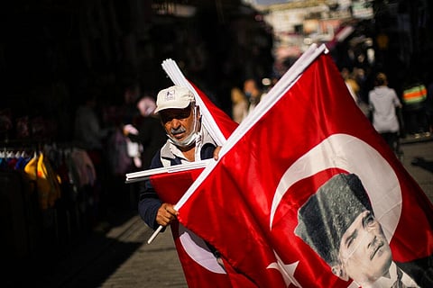 A vendor sells Turkish flags with the portrait of Mustafa Kemal Ataturk, founder of the modern Turkey, in a street market in Istanbul (Photo | AP)