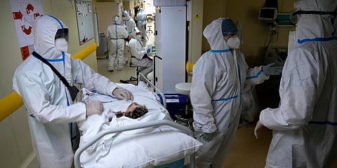 Medics wearing special suits to protect against coronavirus prepare to move a patient with coronavirus at an ICU at the Moscow City Clinical Hospital 52, in Moscow. (Photo| AP)