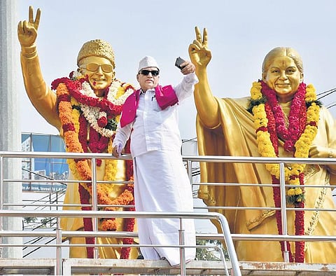 A fan poses for a selfie standing beside a statue of MGR. The former CM still remains popular among fans and political cadre in the State | file photo