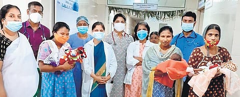 Three women hold their newborn babies after their discharge, along with doctors and staff of Niloufer Hospital on Thursday. All three babies weighed below 1 kg at birth