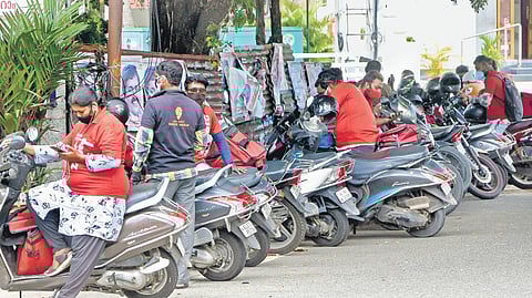 Food delivery executives waiting to pick up orders |B P Deepu