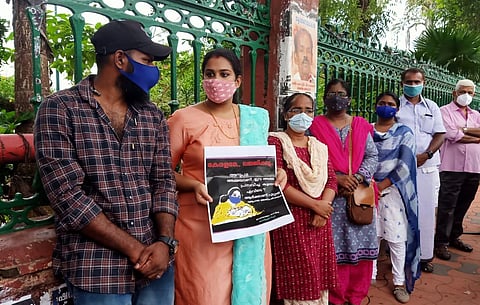 Anupama holds a placard saying that a mother was being denied justice. (Photo | Express)