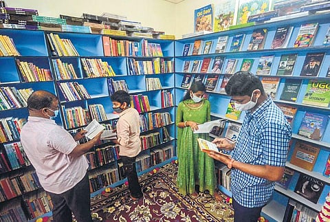 Readers, both adults and youngsters, engrossed in reading;