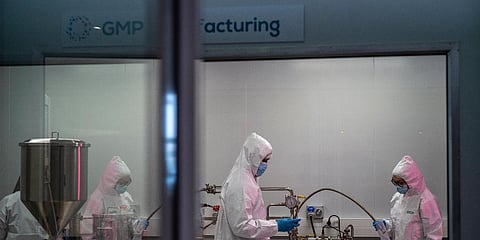 Scientists re-enact the calibration procedure of equipment at an Afrigen Biologics and Vaccines facility in Cape Town, South Africa, Tuesday Oct. 19, 2021. (Photo | AP)