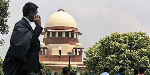 Image of a lawyer walking outside the Supreme Court used for representational purpose only