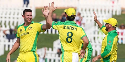 Australia's Josh Hazlewood (L) is congratulated by teammate's Mitchell Marsh, and Aaron Finch, right, after dismissing South Africa's Quinton de Kock. (Photo | AP)