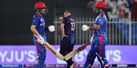 Afghanistan's Najibullah Zadran (R) celebrates after hitting a boundaryduring the T20 World Cup match against Scotland in Sharjah. (Photo| ANI)