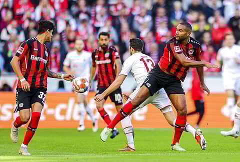 Cologne's Mark Uth and Leverkusen's Jonathan Tah, right, battle for the ball during the Bundesliga soccer match between FC Cologne and Bayer Leverkusen. (Photo | AP)