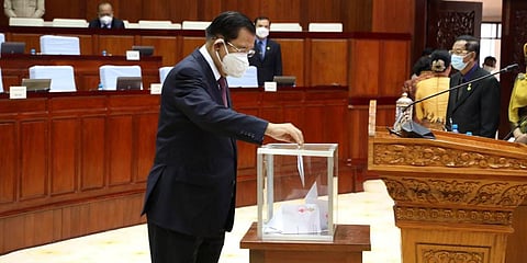 Cambodian Prime Minister Hun Sen drops a ballot into a box in the National Assembly hall in Phnom Penh, Cambodia. (Photo | AP)