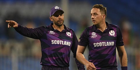Scotland skipper Kyle Coetzer (L) speaks with teammate Josh Davey during a T20 World Cup match against Afghanistan in Sharjah. (Photo| AFP)