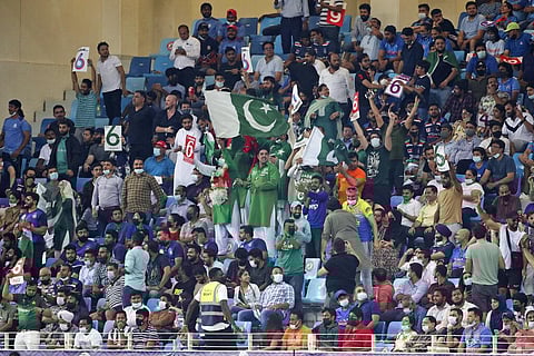 Pakistan fans celebrate a six by captain Babar Azam during the ICC World T20 match between India and Pakistan in Dubai. (Photo | AP)