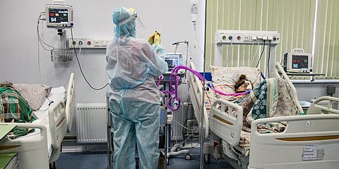 A medical worker wearing a special suit to protect against COVID-19 treats a patient at an ICU in Infectious Hospital No. 23 in Nizhny Novgorod, Russia. (Photo | AP)