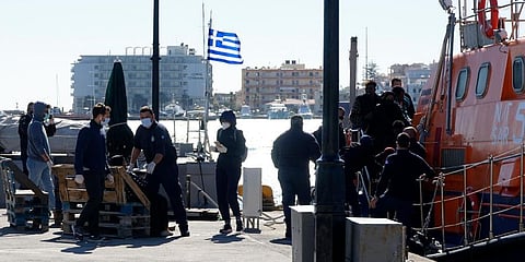 Migrants disembark from a coast guard vessel after an operation on the northeastern Aegean island of Chios, Greece. (Photo | AP)