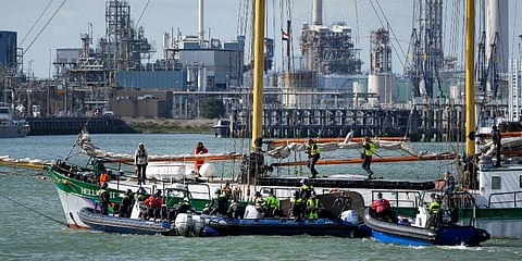 Dutch riot police prepare to board Greenpeace's Beluga II when breaking up a protest by climate activists at a Shell refinery in Rotterdam, Netherlands. (Photo | AP)