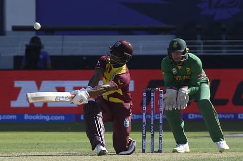 West Indies' Evin Lewis (L) plays a shot during the T20 WC match against South Africa at Dubai International Cricket Stadium, Dubai on October 26, 2021. (Photo | AFP)