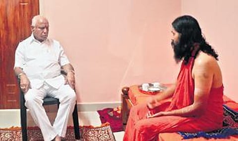 Former CM BS Yediyurappa meets Siddalinga Mahaswami of Shree Shiv Yogashrama at Kalenahalli in Shikaripura taluk on Tuesday | EXPRESS