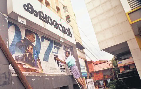 The poster of Daniel Craig’s last Bond movie ‘No Time To Die’ being put up at Kalabhavan theatre at Vazhuthacaud in Thiruvananthapuram. This will be the first movie to be screened when the theatre res