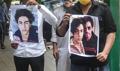 Fans of Bollywood actor Shah Rukh Khan, hold posters written with 'Release Aryan Khan' stand outside Bombay High court in Mumbai. (Photo | PTI)
