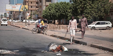 People walk on a street in Khartoum, Sudan, two days after a military coup. (Photo | AP)