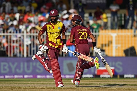 West Indies' Nicholas Pooran (R) and teammate Roston Chase run between the wickets during T20Â WC match against West Indies at Sharjah Cricket Stadium, Sharjah on October 29, 2021. (Photo | AFP)