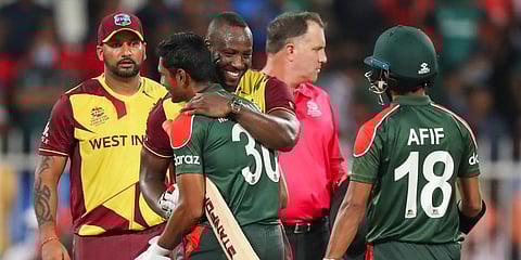 Bangladesh's captain Mohammad Mahmudullah is embraced by West Indies' Dwayne Bravo following a T20 World Cup match in Sharjah. (Photo| AP)