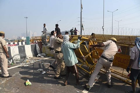 Police barricading being removed from Ghazipur border where a farmers' agitation against the three farm laws is ongoing. (Photo | Parveen Negi/EPS)